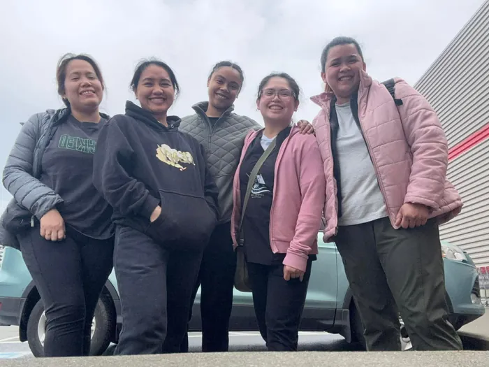 Five Crystal Care team members in winter jackets smiling together outside